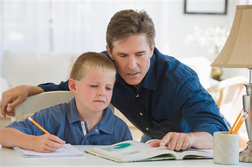 father helping son with homework 